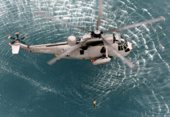 Pictured is a Westland Sea King MK.6 (XV708) from 810 Naval Air Squadron.
The image shows the helicopter 'dipping' a sonar buoy into the water (circa 1999).The Sea king was replaced in Royal Navy sercive by the Merlin Mk1, which was  updated to the Mk2 Merlin in 2014.