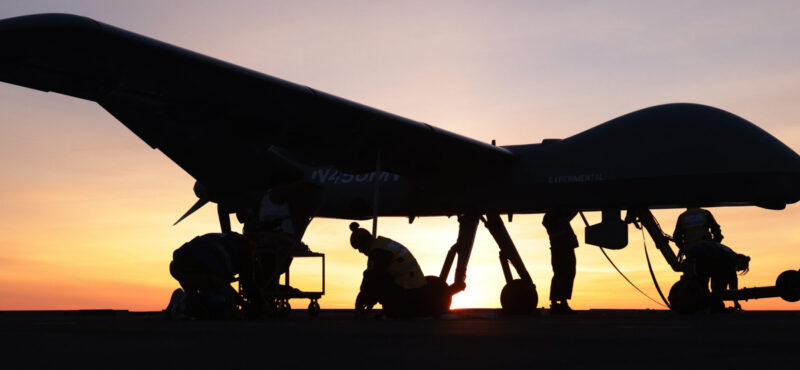 Image of the Mojave unmanned aerial vehicle (UAV), seen here on the flight deck of HMS Prince of Wales.

On 15th November 2023, Codenamed “Mojave”, the specially modified remotely piloted aircraft successfully launched from, and then safely landed back onto, the deck of HMS PRINCE OF WALES in a unique trial off the East Coast of the United States of America. A European first, this trial further unlocks the potential of the UK’s Queen Elizabeth-Class aircraft carriers – designed and principally built around the F-35B Lightning stealth fighter – by demonstrating how modern uncrewed air systems can operate alongside 5th generation crewed aircraft.

After months of planning, successful trials of the largest uncrewed aircraft to ever launch from an aircraft carrier outside of the United States have paved the way for the next generation of air power to be delivered from the Royal Navy’s two supercarriers.

The Mojave trial marks the end of a successful series of experiments and tests with uncrewed aircraft to and from our aircraft carriers this autumn, and follows on from the successful demonstration in September when a small W Autonomous Systems logistics supply aircraft delivered supplies to HMS PRINCE OF WALES in the English Channel.  

The Mojave is an adaptation of the MQ1C Grey Eagle aircraft that has been developed for short take-off and landing (STOL), originally to prove STOL operations were capable at unprepared landing sits. With a 17m wingspan, the UAS is 6m wider than an F-35B Lightning steal fighter, and weighs 1.5 tonnes in its fully loaded configuration. The medium altitude, long endurance, remotely piloted aircraft can provided long-range surveillance and strike capability over areas covering many thousands of miles.