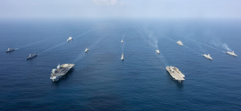 Pictured: 6 October 25 - The UK's Carrier Strike Group forms up with the Indian Navy and Japanese ship Akebono, (front row) HMS Prince of Wales and INS Vikrant are joined by INS Surat, INS Mormugao, HNoMS Roald Amundsen, HMS Richmond, INS Teg, INS Kolkata, INS Tabar, RFA Tidespring and INS Deepak.

The Carrier Strike Group is over halfway through the Operation Highmast deployment. 

Led by UK flagship HMS Prince of Wales and involving a dozen nations, the eight-month mission - known as Operation Highmast - has seen the task group pass through the Mediterranean, Middle East, and Indian Ocean visiting Singapore and Australia, the Carrier Strike Group shifted focus on Asia visiting Japan and South Korea. 

The goal is to reaffirm the UK's commitment to the security of the Mediterranean collective resolve with our allies and showcase British trade and industry. 

Over the course of the deployment, upwards of 4,500 British military personnel will be involved, including nearly 600 RAF and 900 soldiers alongside 2,500 Royal Navy sailors and Royal Marines.